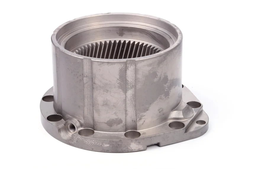 Oblique view of a flanged cylindrical component with internal helical teeth