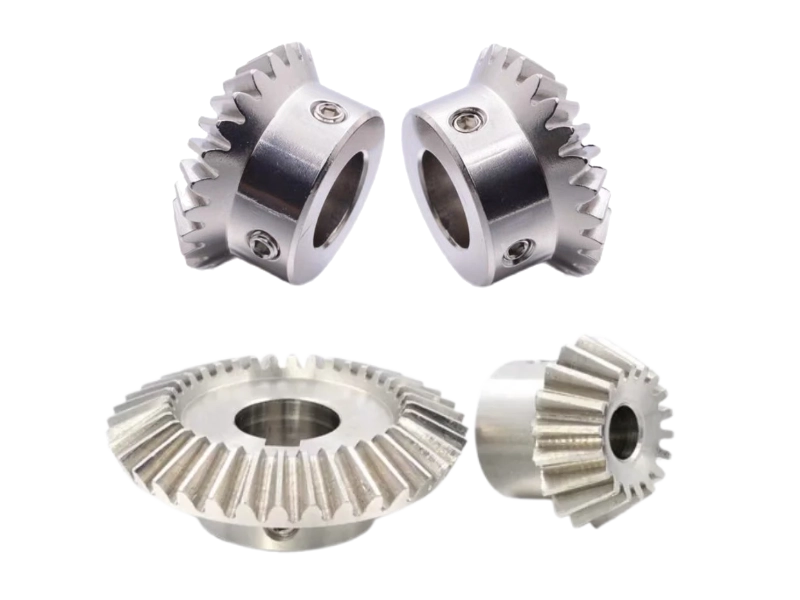 Four metal bevel gears with central bores