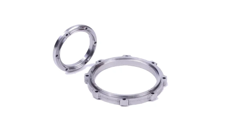 Two ring-shaped metal components with mounting holes